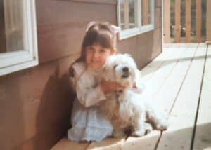 Rachael, young child, with small white dog